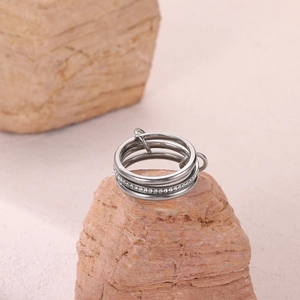 Macro shot of triple-layer stainless steel ring featuring micro-pave cubic zirconia inlay