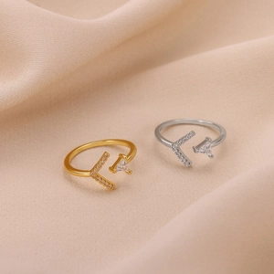Detail of adjustable rose gold and silver rings with cubic zirconia and V-shape design