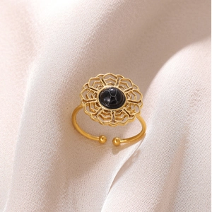 Detail of 18K gold plated bow ring featuring a black stone and hollow geometric design