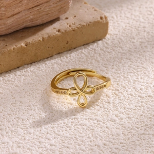 Detailed macro view of 18K gold plated bow ring featuring zircon inlays and an open design