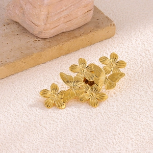 Elegant gold stainless steel brooch with sunflower and butterfly motifs on a textured base
