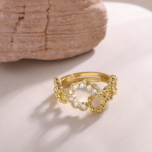 Close-up of golden adjustable ring with micro-set zircons and beaded texture detail