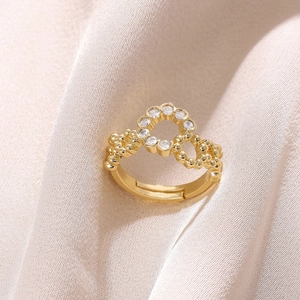 Detailed macro view of 18K gold plated ring with zircons and beaded texture band