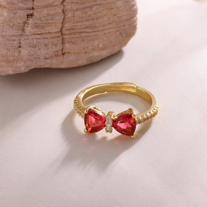 Close-up of 18K gold plated bow ring with red heart zircon and micro-pave detailing