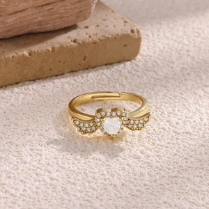 Macro detail of 18K gold plated heart ring with zircon wings and adjustable band