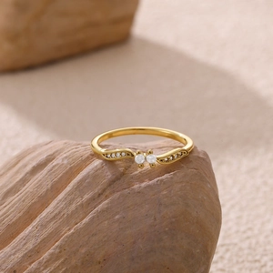 Detailed close-up of 18k gold plated wave ring with double cubic zirconia stones on rock