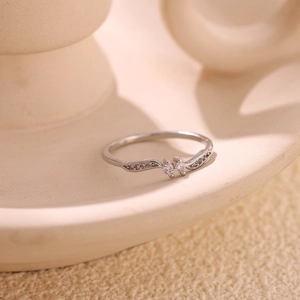 Macro view of wave-shaped ring in 18k gold plated silver with sparkling zircons