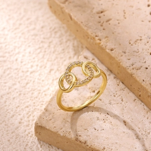 Macro shot of 18k gold plated wave ring with shimmering white zircon stones set in gold