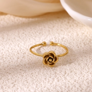 Macro detail of 18K gold plated flower ring with layered petals and open band design