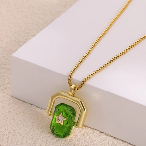 Detailed view of gold stainless steel necklace with rotating green zircon eye pendant