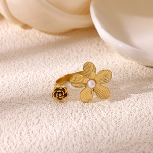 Detailed macro view of 18K gold floral ring featuring pearl and textured petals