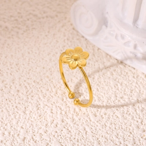 Detail of 18K gold flower ring with textured petals and adjustable open band design