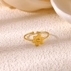 Macro shot of 18K gold plated flower ring with pearl and zircon details on stone base