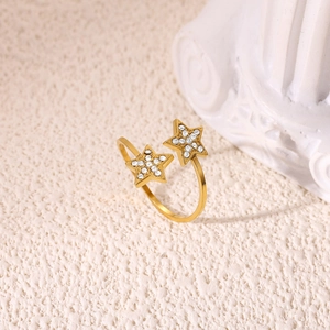 Detail view of 18K gold plated open ring featuring star motifs with pavé zircon setting