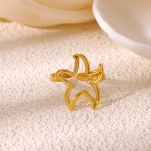 Macro detail of a 18K gold-plated starfish open ring with polished metallic texture