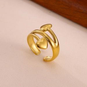 Detail of matte gold double heart open ring with a refined brushed metal texture