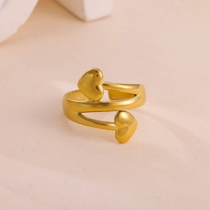 Detailed close-up of a gold-plated heart wrap ring with a polished metallic finish