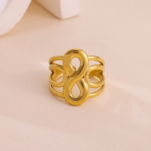 Macro view of gold plated stainless steel ring with infinity symbol and hollow design
