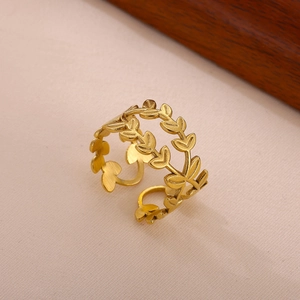 Detail of gold laurel leaf adjustable ring with a brushed metallic texture and romantic style