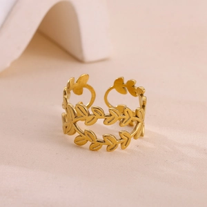 Detail of gold olive branch open ring with elegant leaf pattern and hollow design