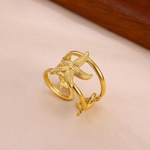 Detailed view of a gold double-layer ring featuring a textured starfish and a sea star charm