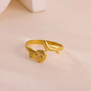 Macro shot of gold-plated open ring featuring nautical shell and dolphin motifs