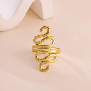 Detailed close-up of a gold-plated spiral ring with brushed metal texture on a soft background