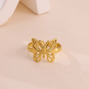Detailed close-up of a gold-plated stainless steel ring featuring a hollow butterfly design