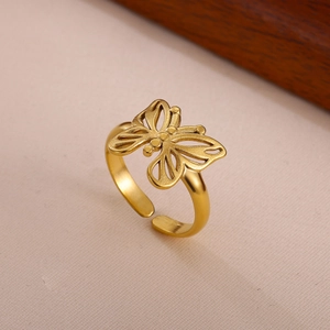 Close-up of golden butterfly ring with matte brushed texture and adjustable open band