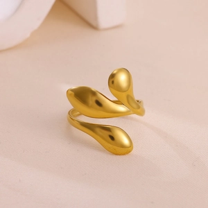 Macro shot of polished gold-plated organic ring with interlocking droplet-shaped elements