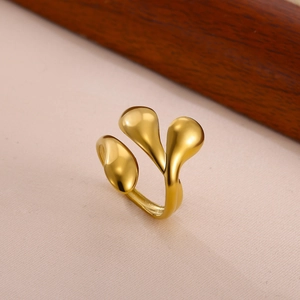 Close-up of golden multi-head droplet ring with adjustable open band and mirror polish