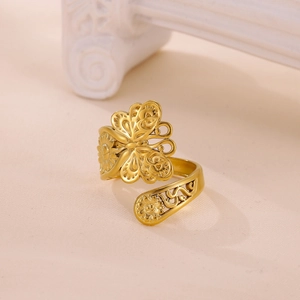 Detailed view of gold-plated open ring with intricate butterfly and floral cut-outs