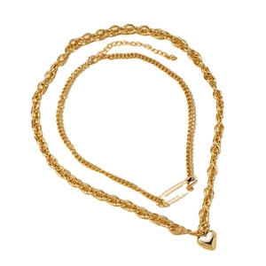 Double-layered gold necklace with heart pendant and safety pin charm on cable chain
