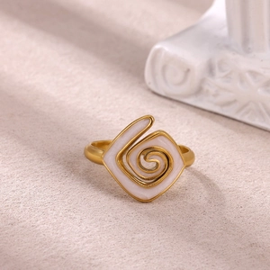 Detailed macro view of a gold-plated snake-shaped ring with elegant white enamel finish