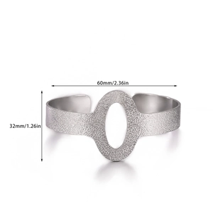 Detail view of silver matte open bangle with hammered texture and dimensions 60mm by 32mm