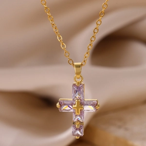 Dettaglio della collana con ciondolo a croce con cristalli viola e catena placcata oro