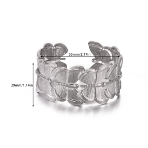 Macro detail of silver butterfly cuff bangle with fine etched wing textures and 29mm width