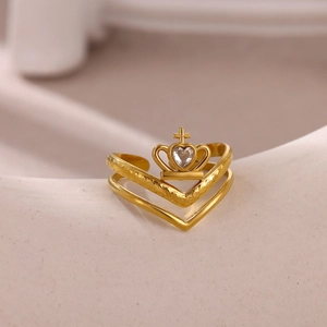 Macro detail of gold crown ring featuring a heart zircon and hammered double-V band