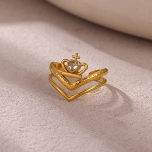 Macro detail of gold V-shaped ring with crown design and heart-shaped zircon stone
