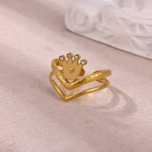 Detail of gold-plated crown heart ring with shimmering crystals and hammered texture