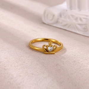 Detailed macro view of a gold-plated crown ring with heart-shaped zircon and cross detail