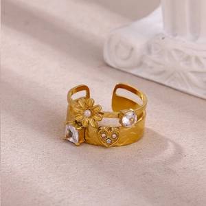 Detail of gold multilayer snake ring with sun flower pearl and heart zirconia stones