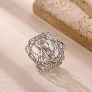 Macro shot of silver irregular multi-layer hollow wide band ring with organic lines