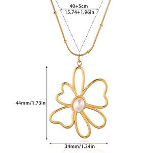 Gold hollow flower necklace with pearl center and sleek snake chain on white background