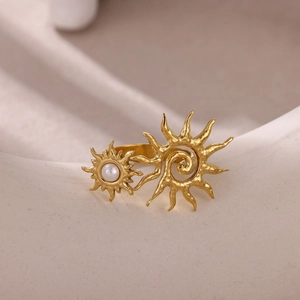 Detailed close-up of golden bohemian ring with pearl inlay and sunburst design