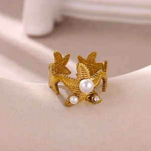Detail of gold starfish ring featuring textured starfish with pearls and mini rhinestones