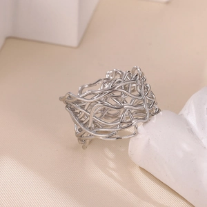 Detailed view of silver stainless steel ring with irregular hollow woven wire design