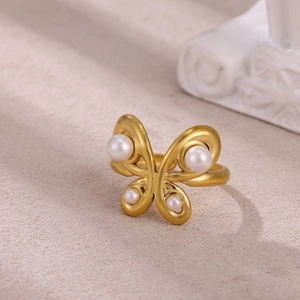 Detailed view of a gold-plated butterfly ring with elegant pearl wing accents