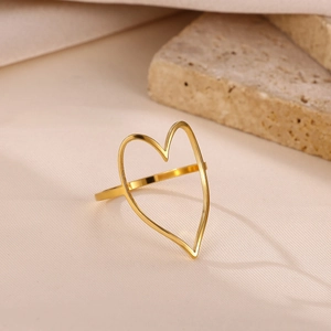 Detailed view of hollow irregular heart ring in gold stainless steel on stone
