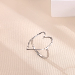 Detail of a hollow heart-shaped silver stainless steel ring with a polished metallic finish